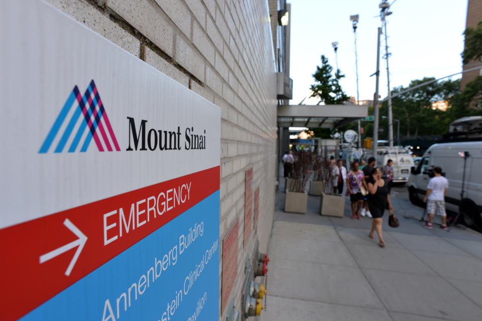 Television trucks on Madison Avenue outside the emergency room entrance to Mount Sinai Hospital August 4, 2014  (STAN HONDA/AFP/Getty Images)