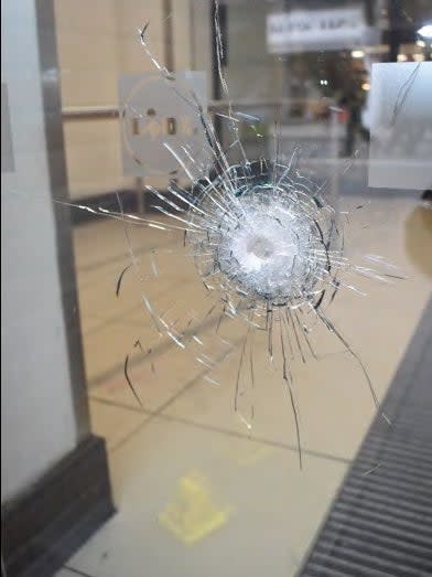 A bullet hole in the front of a Lidl supermarket in Streatham High Road after police opened fire at terrorist Sudesh Amman (Metropolitan Police)