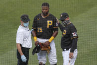 A Pittsburgh Pirates trainer and manager Derek Shelton check on Gregory Polanco as Phillip Evans receives medical attention after the two collided along the right field fence while chasing a fly ball by Detroit Tigers' Miguel Cabrera during the sixth inning of a baseball game Saturday, Aug. 8, 2020, in Pittsburgh. Evans was taken off on a stretcher while Polanco stayed in the game. (AP Photo/Keith Srakocic)