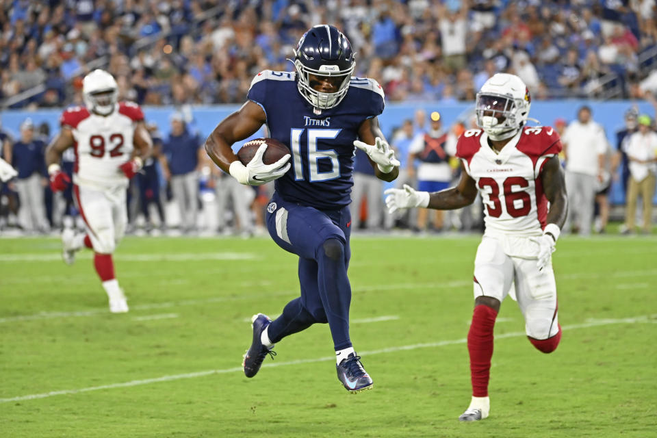 Tennessee Titans wide receiver Treylon Burks (16) leaps into the end zone past Arizona Cardinals cornerback Josh Jackson (36) as Burks scores a touchdown on a 14-yard pass completion in the first half of a preseason NFL football game Saturday, Aug. 27, 2022, in Nashville, Tenn. (AP Photo/Mark Zaleski)