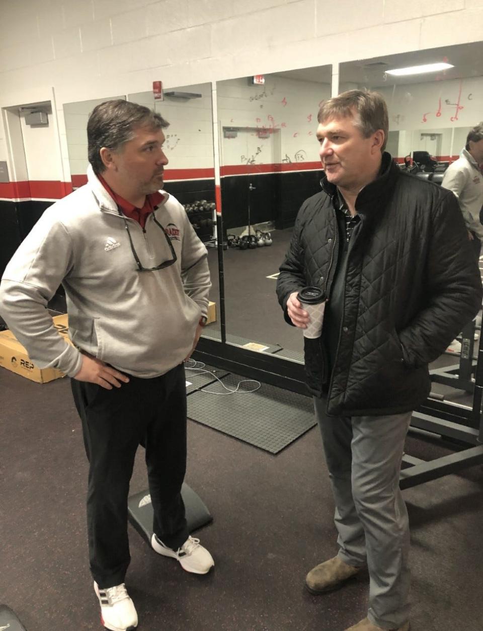UGA coach Kirby Smart (right) talks with Savannah Christian coach Baker Woodward in the SCPS weight room during a recruiting visit Tuesday.