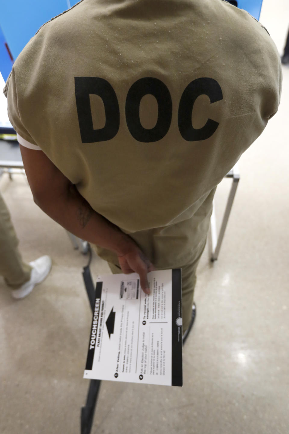 FILE - In this March 14, 2020, file photo, a Cook County jail inmate participates in early voting for the Illinois primary at the jail in Chicago. Most of the three-quarters of a million people held in U.S. jails have the right to vote, but many of them are unable to, stymied by misinformation, limited access to registration and ballots and confusion from the officials in charge. The advocacy organization released a report detailing voting access for jail inmates with Rainbow PUSH Coalition, a civil rights advocacy group formed by the Rev. Jesse Jackson, on Friday, Oct. 2, 2020. (AP Photo/Charles Rex Arbogast, File)