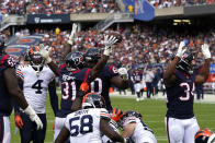 Houston Texans running back Dameon Pierce (31) celebrates with A.J. Cann (60) after rushing for a touchdown against the Chicago Bears during the first half of an NFL football game Sunday, Sept. 25, 2022, in Chicago. (AP Photo/Charles Rex Arbogast)