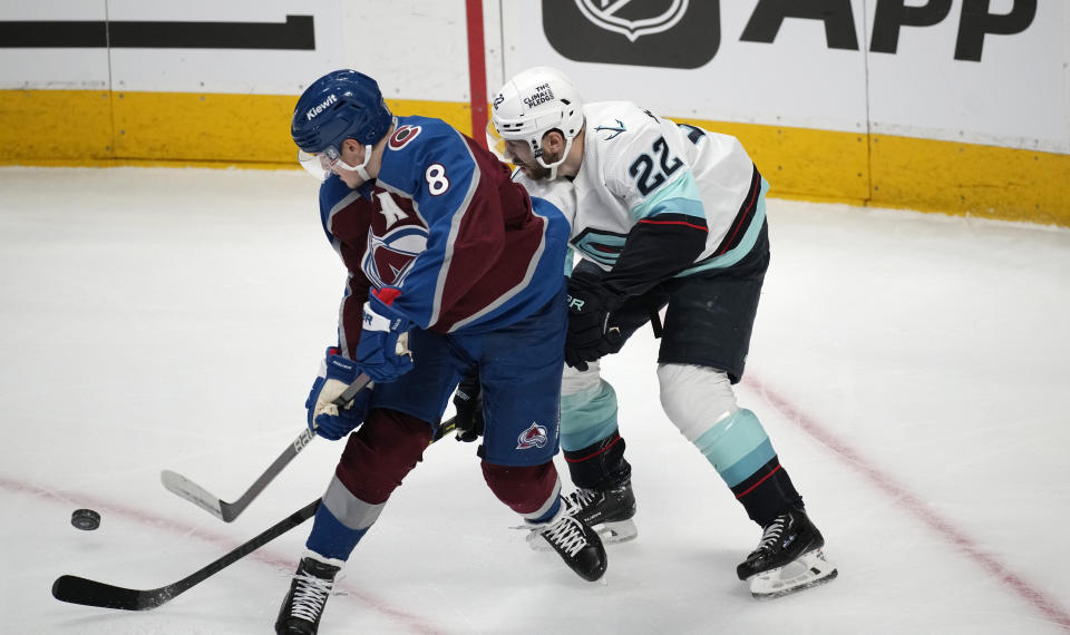 Colorado Avalanche defenseman Cale Makar, left, becomes entangled with Seattle Kraken right wing Oliver Bjorkstrand in the first period of Game 7 of an NHL first-round playoff series Sunday, April 30, 2023, in Denver. (AP Photo/David Zalubowski)