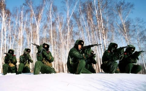 Chinese soldiers take aim during training on the snow covered Changbai Mountain, Jilin province, - Credit: Reuters