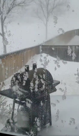 Snow is seen piling (rear) during a blizzard in Commerce City, Colorado, U.S. March 13, 2019 in this picture obtained from social media. Mandatory credit TWITTER @MILE_WARRIOR/via REUTERS