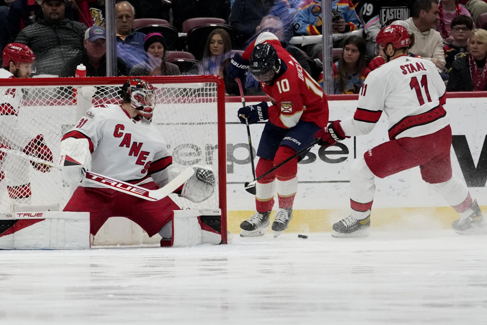 Carolina Hurricanes goaltender Frederik Andersen (31) and center Jordan Staal (11) defend as Florida Panthers left wing Anthony Duclair (10) sets up a shot during the first period of an NHL hockey game, Thursday, April 13, 2023, in Sunrise, Fla. (AP Photo/Lynne Sladky)