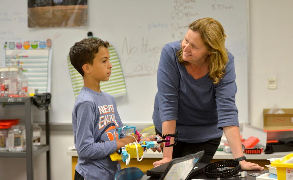 Monomoy Middle School teacher Nancy Gifford, right, talks with fifth grader Lucas Bicalho during the fifth grade robotics class in Chatham. The students were working on their robots and programming them during a class on May 18. Gifford was named Massachusetts STEM (science, technology, engineering and math) Teacher of the Year.