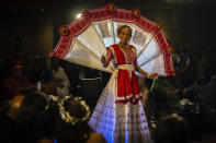 A participant wearing a traditional walks on a ramp during the Miss Trans Northeast 22, beauty pageant in Guwahati, India, Wednesday, Nov. 30, 2022. In a celebration of gender diversity and creative expression, a beauty pageant in eastern Indian state of Assam brought dozens of transgender models on stage in Guwahati. Sexual minorities across India have gained a degree of acceptance especially in big cities and transgender people were given equal rights as a third gender in 2014. But prejudice against them persists and the community continues to face discrimination and rejection by their families. (AP Photo/Anupam Nath)