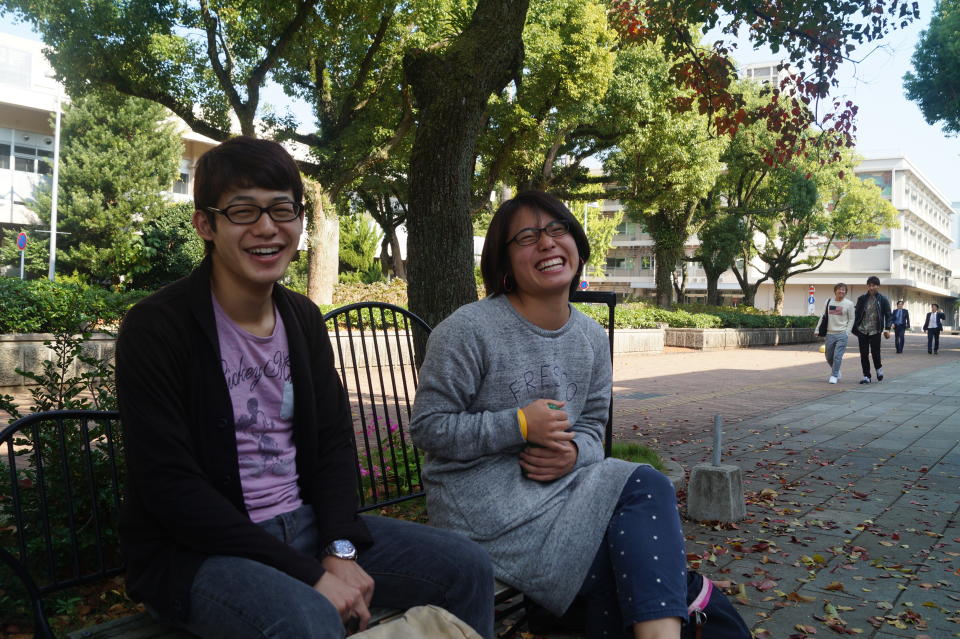 Nagasaki University students Hanako Misuoka and Jo Takeda, both 21, share a few laughs on campus. (Photo: Michael Walsh/Yahoo News)