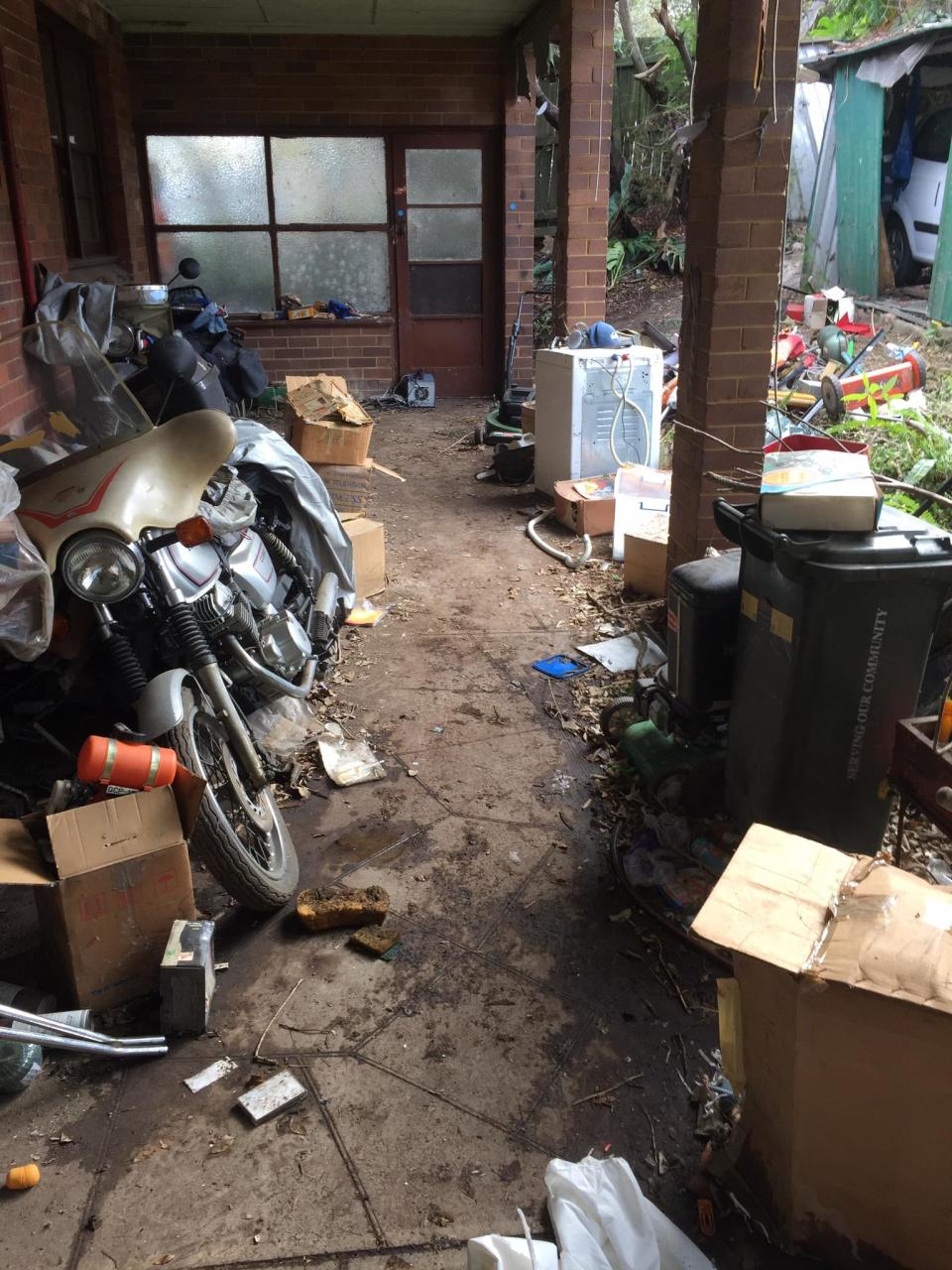 A motorbike and other clutter is seen at a house on Greendale Street, Greenwich belonging to hoarder Bruce Roberts.