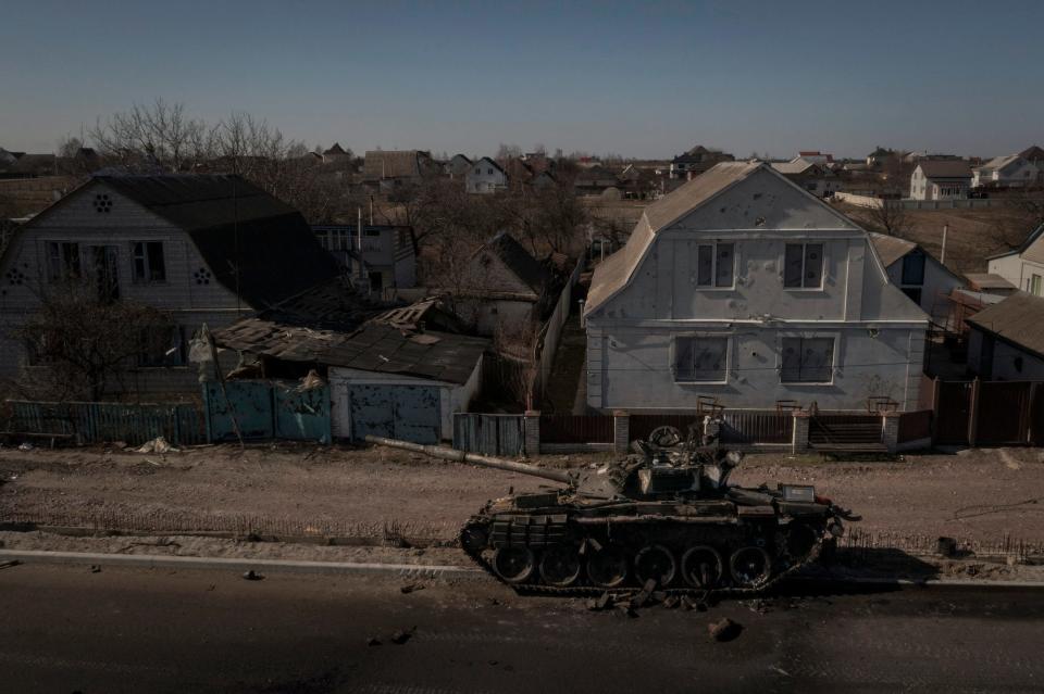 A view of a destroyed Russian tank in front of houses in Brovary, outside Kyiv, March 10 2022