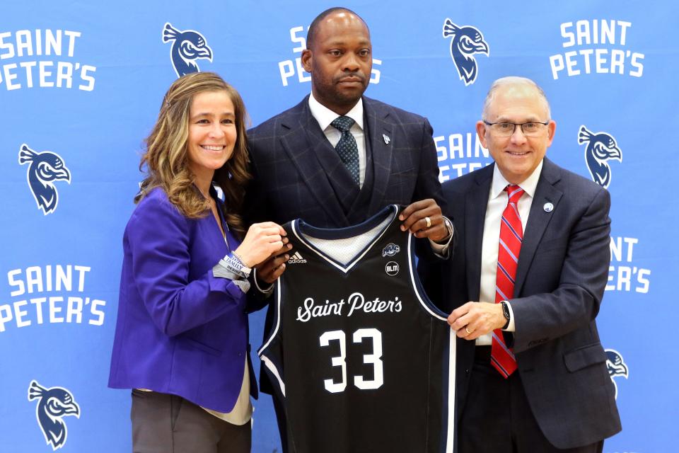 St. Peter's University Athletic Director, Rachelle Paul, Head Basketball Coach, Bashir Mason and President Eugene Cornacchia pose at a press conference, in Jersey City. Wednesday, April 13, 2022