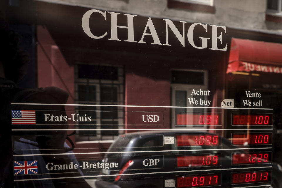 Exchange rates for U.S dollars and the Euro currencies are displayed outside a change office Wednesday, July 13, 2022 in Paris. The euro on Tuesday fell to parity with the dollar for the first time in nearly 20 years.(AP Photo/Thomas Padilla)