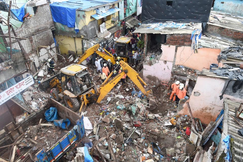 Rescue operation underway after a building collapsed on another structure in Malwani area on Wednesday night, in Mumbai. At least eight children and three adults died and seven other people were injured.