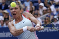 Simona Halep, of Romania, returns a shot to Daria Snigur, of Ukraine, during the first round of the US Open tennis championships, Monday, Aug. 29, 2022, in New York. (AP Photo/Seth Wenig)