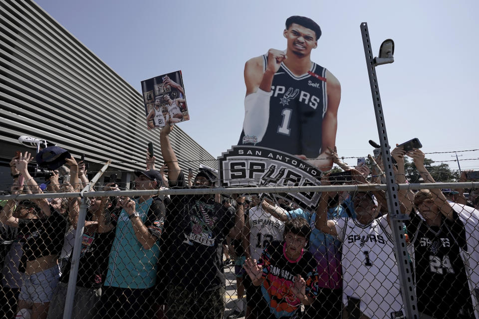 Fans press against a fence as San Antonio Spurs NBA basketball first-round draft pick Victor Wembanyama arrives in San Antonio, Friday, June 23, 2023. (AP Photo/Eric Gay)