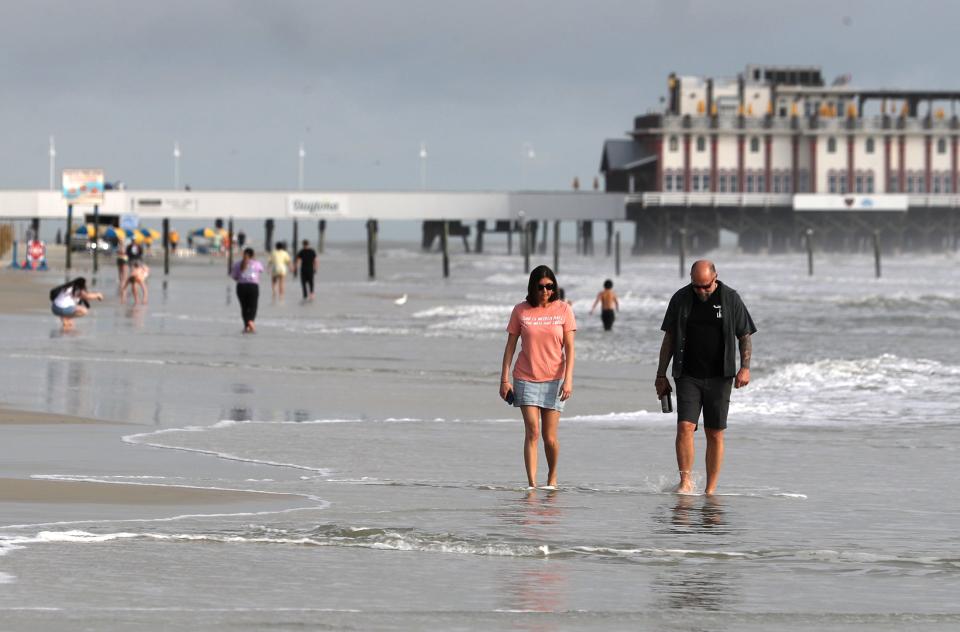 Beachgoers splash along the sand near Sun Splash Park in Daytona Beach. This weekend's weather forecast calls for the typical mix of sun and showers in Daytona Beach, despite potential tropical storm activity in the Gulf of Mexico.