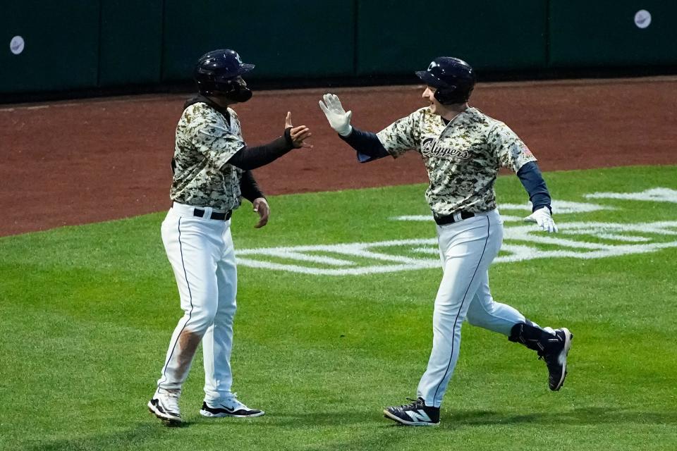 Apr 3, 2024; Columbus, OH, USA; Columbus Clippers first baseman Kyle Manzardo (9) high fives third baseman Juan Brito (24) after hitting a two-run homerun in the fifth inning against the Omaha Storm Chasers during Opening Day at Huntington Park.