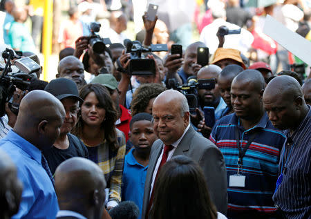 South Africa's outgoing Finance Minister Pravin Gordhan (C) looks on after speaking to supporters outside his offices in Pretoria, South Africa, March 31, 2017. REUTERS/Siphiwe Sibeko