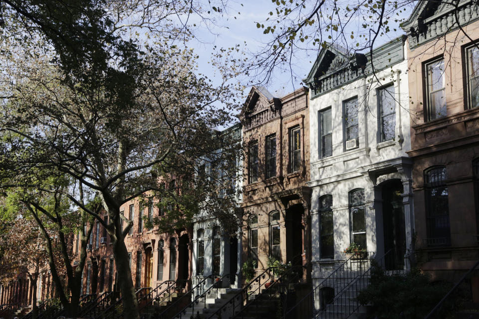 Brownstone buildings line a street in the Park Slope neighborhood in the Brooklyn borough of New York that Mayor-elect Bill de Blasio calls home, Thursday, Nov. 14, 2013. Now de Blasio faces a crucial early decision: should he leave Park Slope behind to move to the mayor’s official residence, stately Gracie Mansion on Manhattan’s Upper East Side? But most of his neighbors in Park Slope, proud of his rise and skeptical that he could be happy anywhere else, believe that he should stay in the neighborhood he’s long called home. (AP Photo/Mark Lennihan)