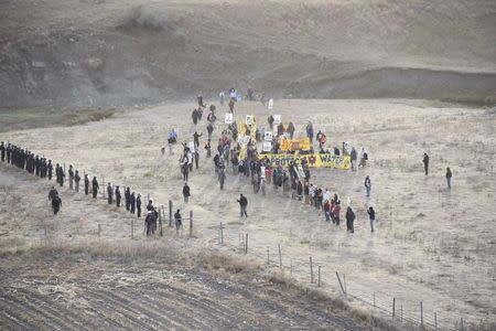 Protesters are confronted by police near a pipeline being built by a group of companies led by Energy Transfer Partners LP at a construction site in North Dakota, October 22, 2016, Photo courtesy Morton County Sheriff's Office/Handout via REUTERS