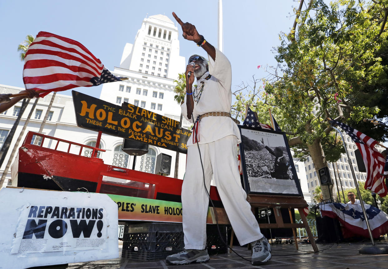 Activist Ted Hayes with a model of a slave ship as he called for reparations during a 2013 rally in Los Angeles to commemorate the 50th anniversary of the March on Washington.