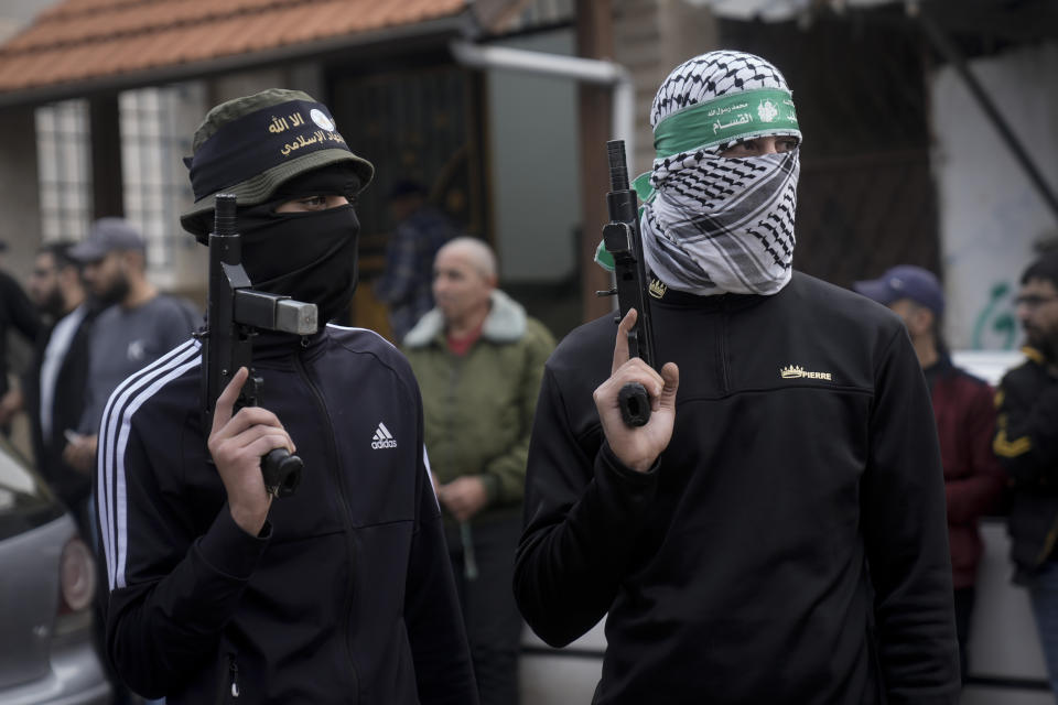 Palestinian gunmen attend the funeral of Moaz Zahran, at Al-Far'a Camp, West Bank, Wednesday, Dec. 6, 2023. Palestinian health officials say that the Israeli military raided parts of the northern West Bank, sparking clashes with local militants that killed two Palestinians. (AP Photo/Majdi Mohammed)