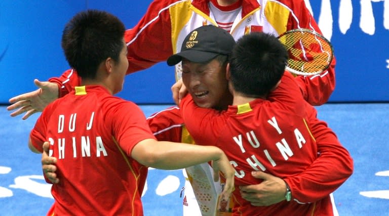 China's badminton duo Du Jing (L) and Yu Yang celebrate with head coach Li Yongbo after their gold-medal victory at the 2008 Beijing Olympic Games