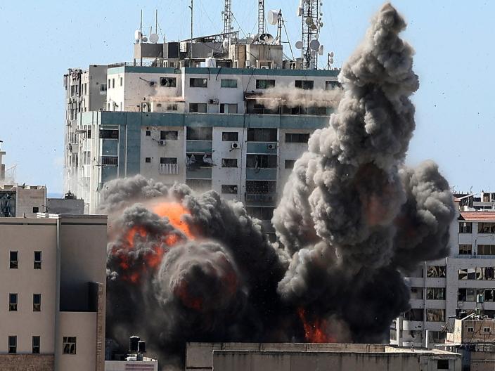 Smoke billows from a media building in Gaza that was struck by Israeli airstrikes