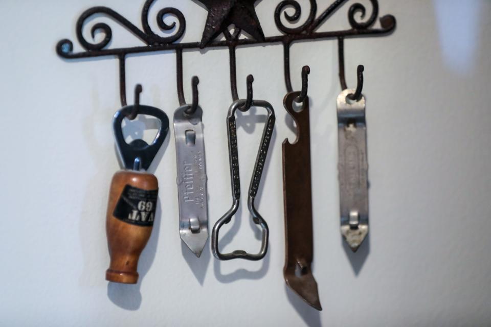 A row of bottle openers hang on the wall at Nelson Maylone's home in Royal Oak. Maylone's father owned and operated a bar when he was a boy growing up.