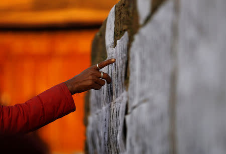 A man searches for his name on the voters list near a polling station during the parliamentary and provincial elections in Bhaktapur, Nepal December 7, 2017. REUTERS/Navesh Chitrakar