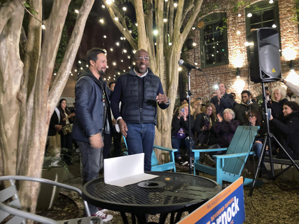 Composer Lin-Manuel Miranda, left, introduces Georgia Democratic Sen. Raphael Warnock at a Latino voter rally in Atlanta on Wednesday, Oct. 19, 2021. Miranda is one of a number of celebrities trying to sway voters, although it's unclear how much influence they have. (AP Photo/Jeff Amy)