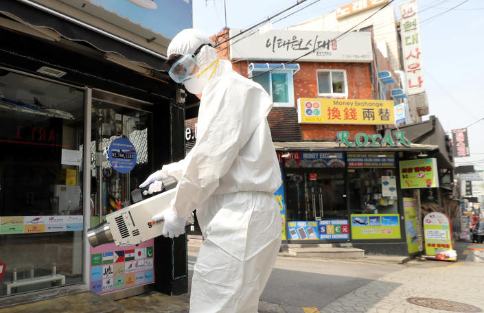 Image: Quarantine worker in Itaewon neighborhood of Seoul (Yonhap / Reuters)