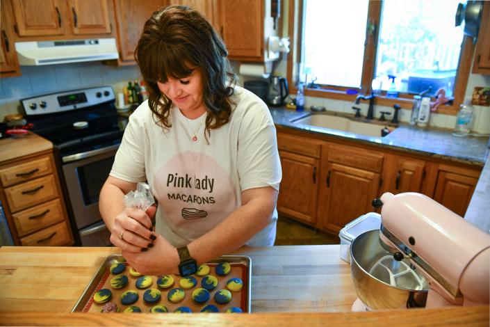 Nichol Wojcik makes a fresh batch of brightly colored macarons as part of her business, Pink Lady Macarons, Tuesday, Oct. 5, 2021, in St. Cloud.