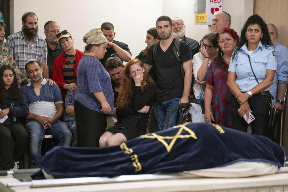 Mourners attend the funeral of Batsheva Nigri, at a cemetery in the West Bank Jewish settlement of Kfar Etzion, Monday, Aug. 21, 2023. Israeli authorities say that a suspected Palestinian attacker has killed an Israeli woman and seriously wounded a man in the incident. (AP Photo/Ohad Zwigenberg)