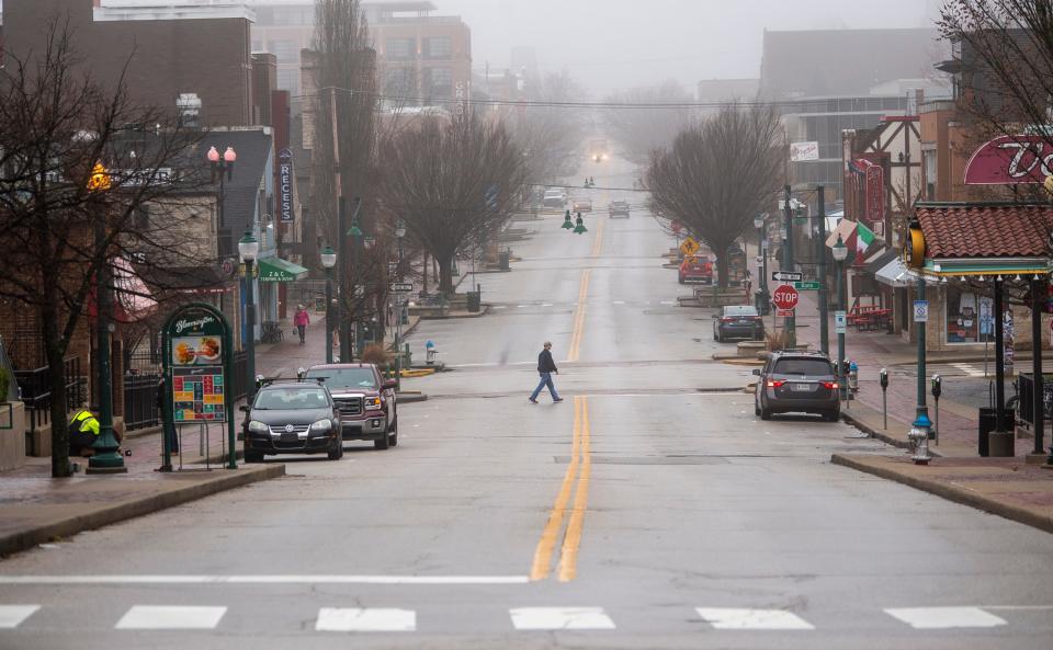 A man walks across a mostly empty East Kirkwood Avenue in mid-March 2020. (Rich Janzaruk / Herald-Times)