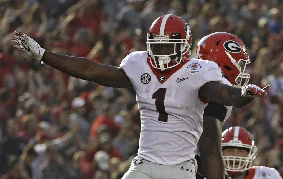 Georgia running back Sony Michel (1) celebrates with offensive tackle Kendall Baker, right, after Michel scored a touchdown against Oklahoma during the second half of the Rose Bowl NCAA college football game Monday, Jan. 1, 2018, in Pasadena, Calif. (AP Photo/Jae C. Hong)