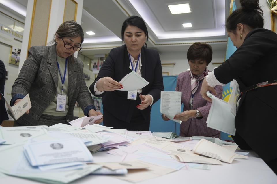 Election commission members count ballots at a polling station in Almaty, Kazakhstan, Sunday, March 19, 2023. Voters in Kazakhstan cast ballots on Sunday after a short but active campaign for seats in the lower house of parliament that is being reconfigured in the wake of deadly unrest that gripped the resource-rich Central Asian nation a year ago. (Vladimir Tretyakov/NUR.KZ via AP)