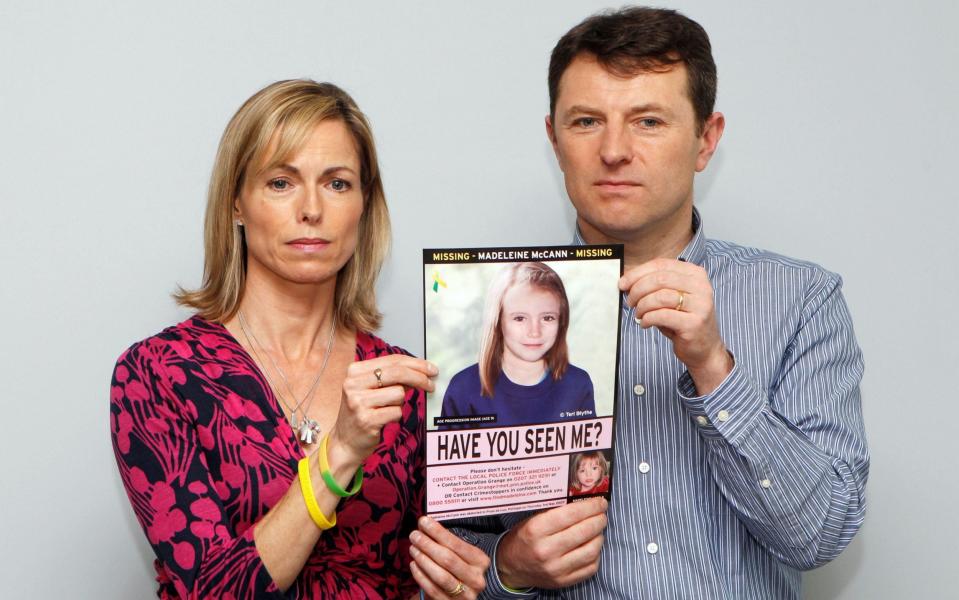 Kate and Gerry McCann pose with a computer generated image of how their missing daughter Madeleine might look now - REUTERS