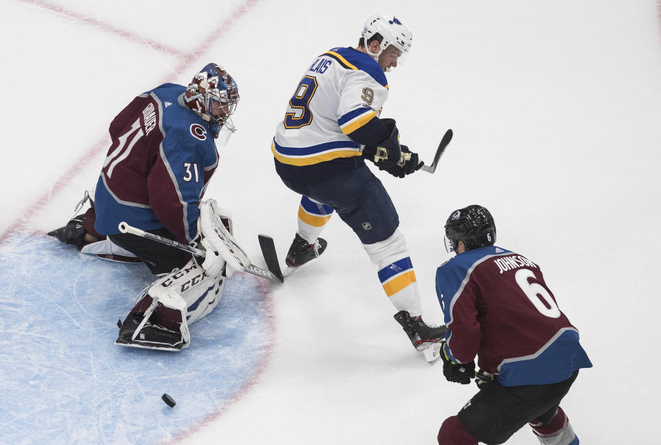 Colorado Avalanche goalie Philipp Grubauer (31) makes a save as St. Louis Blues' Sammy Blais (9) tries to screen the shot during the third period of an NHL hockey playoff game Sunday, Aug. 2, 2020, in Edmonton, Alberta. (Jason Franson/The Canadian Press via AP)