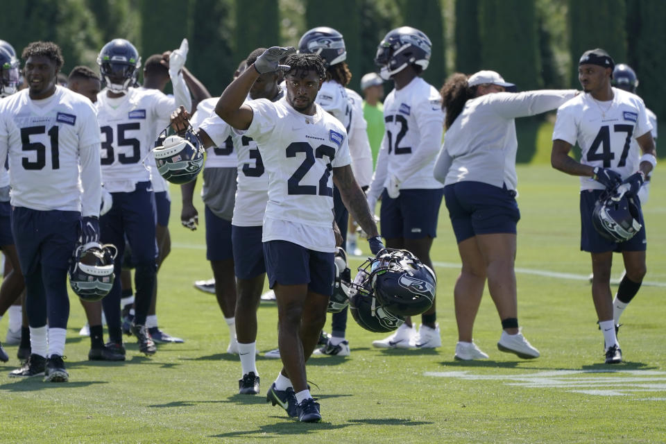 Seattle Seahawks rookie cornerback Tre Brown (22) carries helmets as he waves to fans after NFL football practice Wednesday, July 28, 2021, in Renton, Wash. (AP Photo/Ted S. Warren)