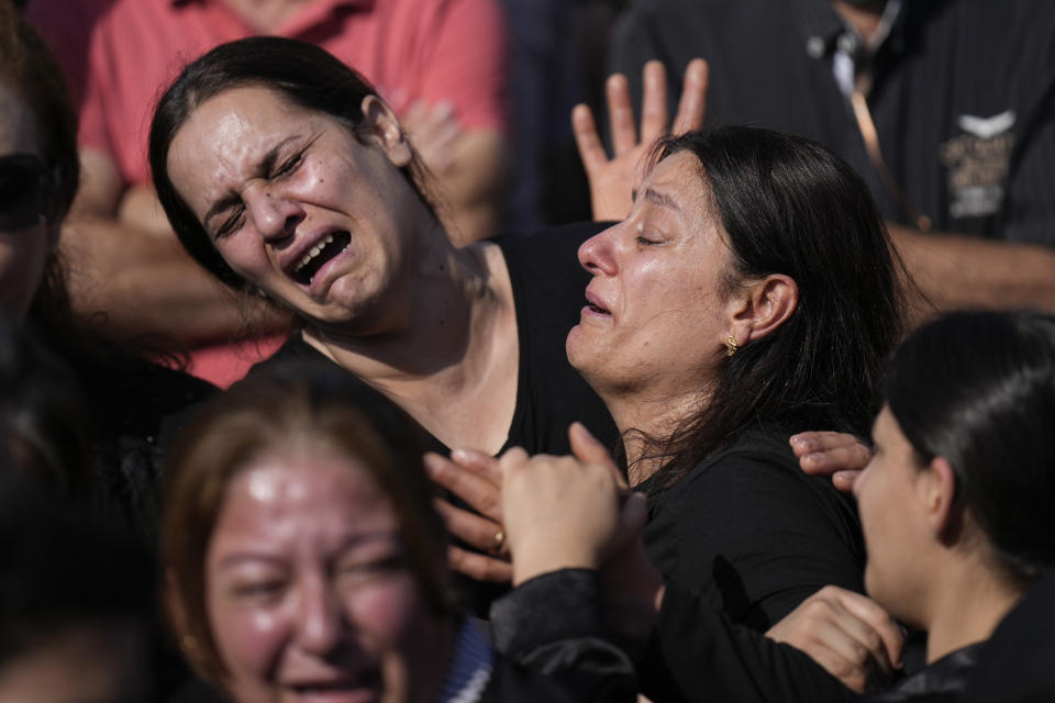 Iraqi women react during a funeral for the victims of a deadly fire at a wedding hall, in the district of Hamdaniya, Nineveh province, Iraq, Friday, Sept. 29, 2023. A fire that raced through a hall hosting a Christian wedding in northern Iraq killed multiple people, authorities said. (AP Photo/Hadi Mizban)