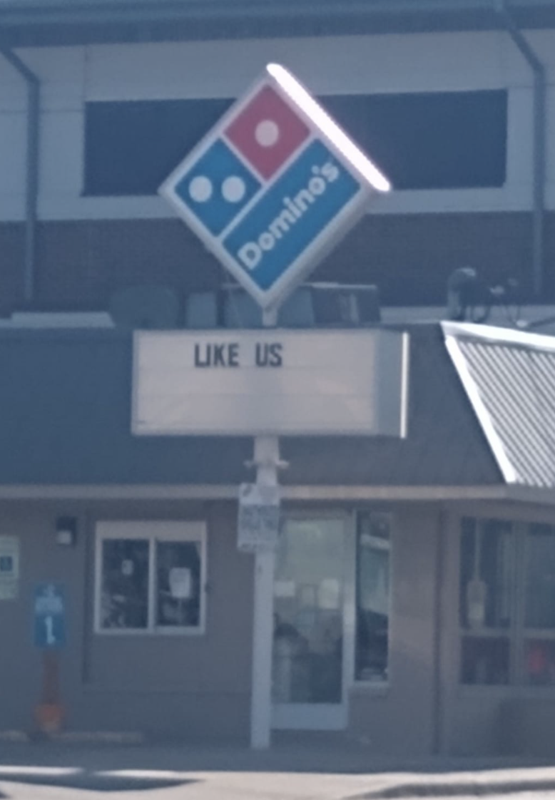 sign reading like us below a Domino's logo