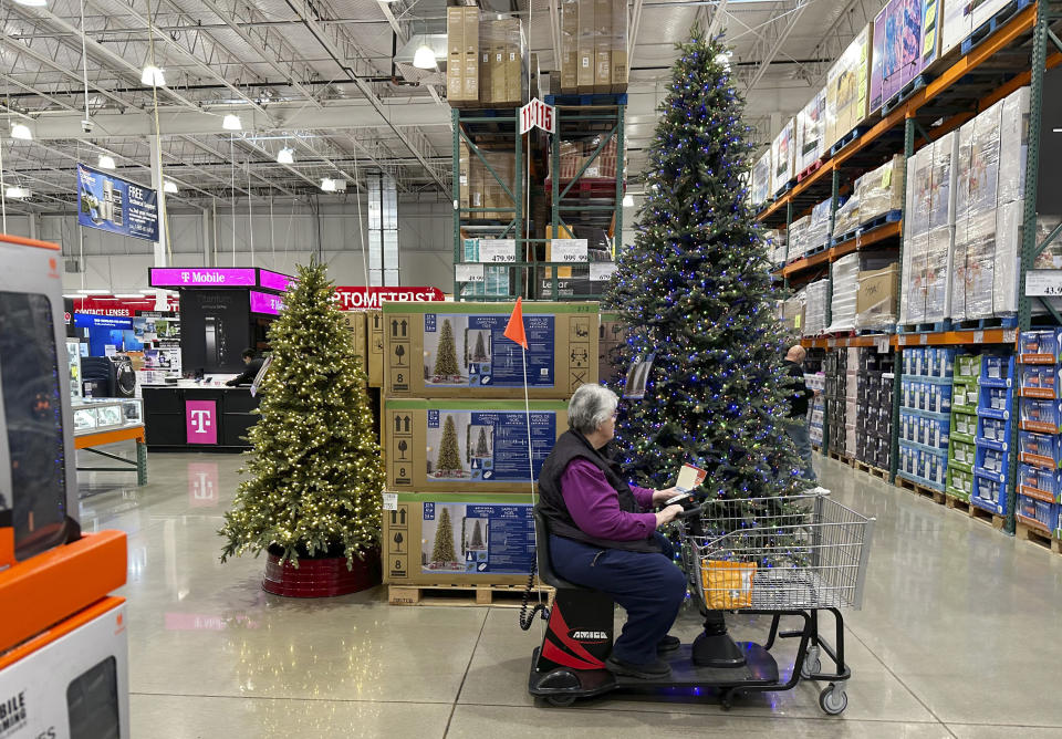 A shopper passes by a display of Christmas trees in a Costco warehouse Thursday, Oct. 26, 2023, in Sherian, Colo. On Wednesday, the Commerce Department releases U.S. retail sales data for October. (AP Photo/David Zalubowski)