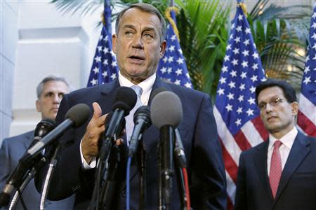 U.S. House Speaker John Boehner (R-OH) (C) is flanked by House Majority Whip Rep. Kevin McCarthy (R-CA) (L) and Majority Leader Rep. Eric Cantor as he speaks to reporters at the U.S. Capitol in Washington, October 15, 2013. REUTERS/Jonathan Ernst
