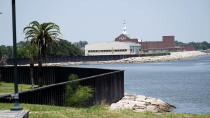 A seawall, which will be increased in size, is shown along the banks near downtown Thursday, July 26, 2018, in Port Arthur, Texas. The oil industry wants the government to help protect some of its facilities on the Texas Gulf Coast against the effects of global warming. One proposal involves building a nearly 60-mile “spine” of flood barriers to shield refineries and chemical plants. Many Republicans argue that such projects should be a national priority. But others question whether taxpayers should have to protect refineries in a state where top politicians still dispute whether climate change is real. (AP Photo/David J. Phillip)