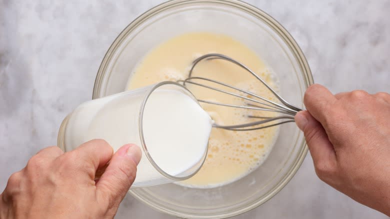 Pouring milk into pancake batter