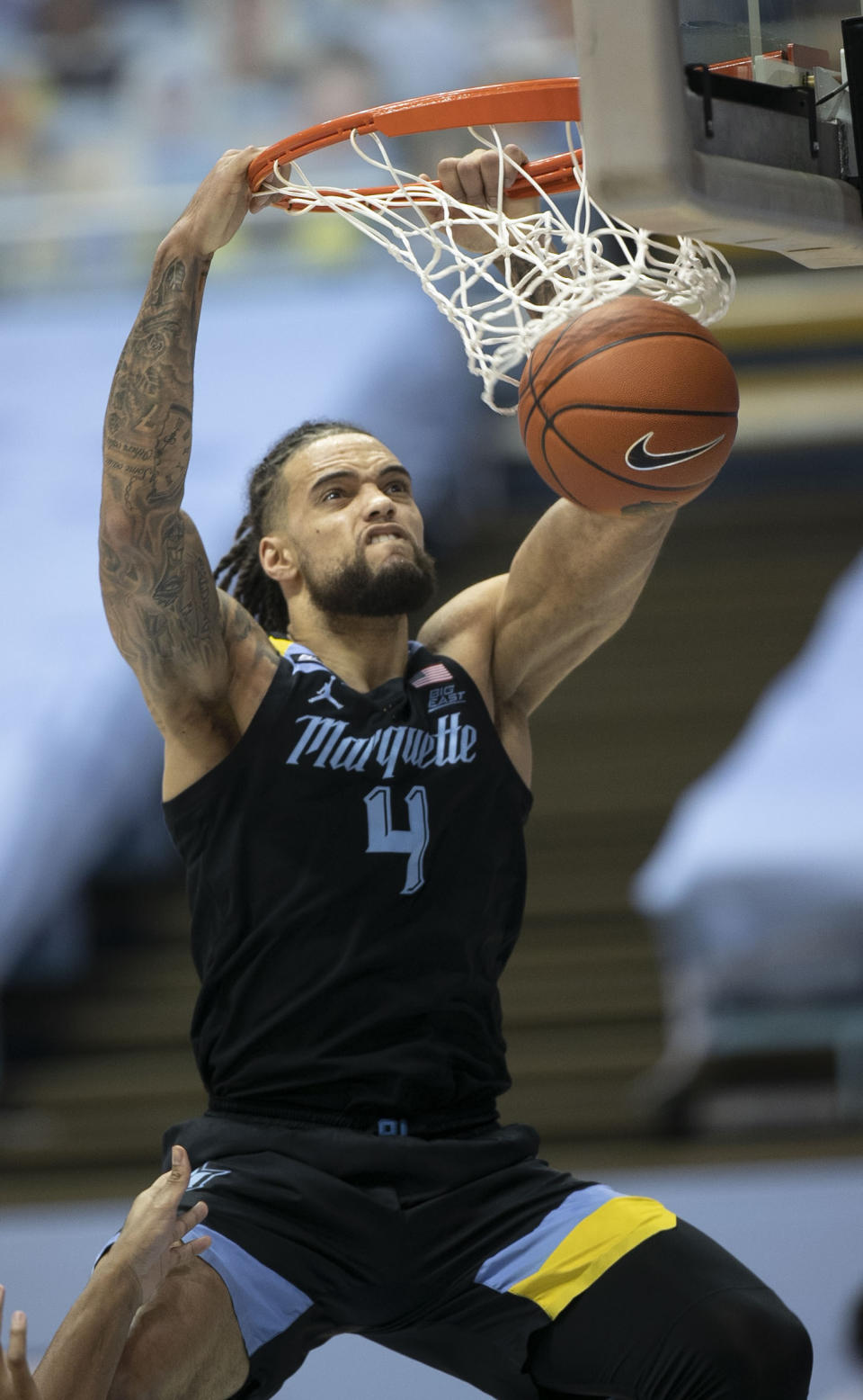 FILE - Marquette's Theo John (4) dunks against North Carolina during the second half of an NCAA college basketball game in Chapel Hill, N.C., in this Wednesday, Feb. 24, 2021, file photo. Former Marquette forward Theo John says he’s transferring to Duke. John said via Twitter on Friday, April 16, 2021, that “after conversations with my family, I have decided that next year I will be attending Duke University for my final year of eligibility.” (Robert Willett/The News & Observer via AP, File)