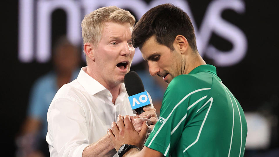 Jim Courier is seen here speaking to Novak Djokovic at the 2020 Australian Open.